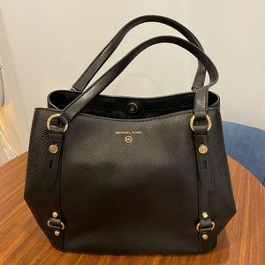 Medium sized, black Michael Kors handbag.